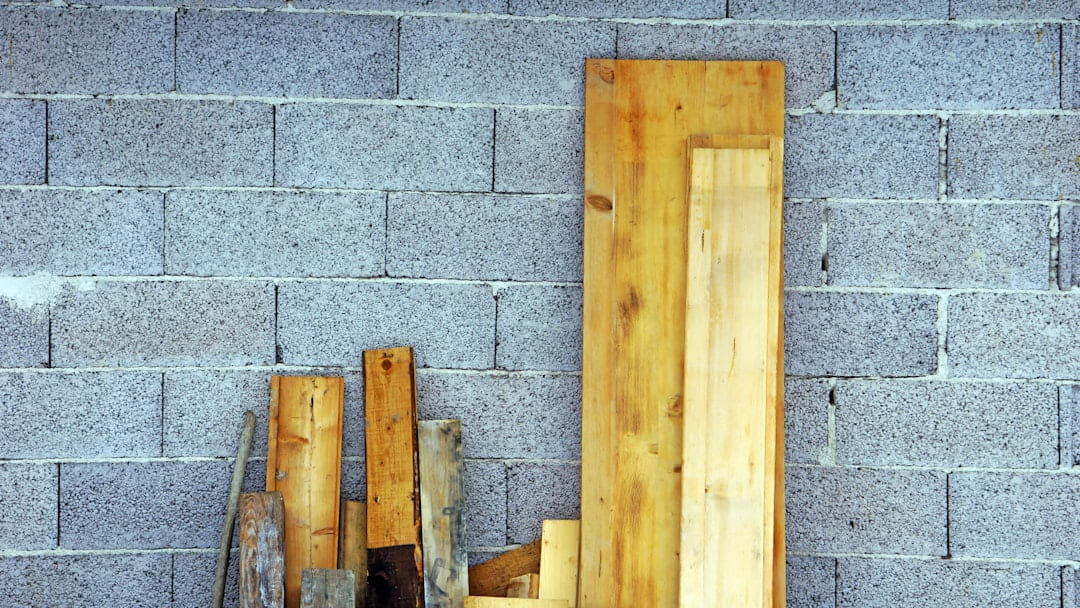 brown wooden board on gray concrete wall on Hammer & Home