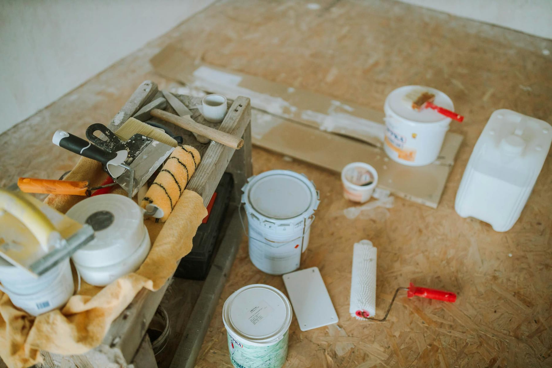 Overhead shot of tools and paint supplies for a home renovation project. on Hammer & Home