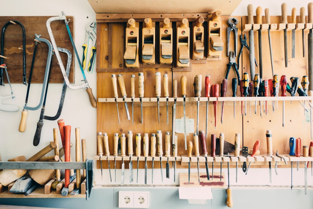 assorted handheld tools in tool rack on Hammer & Home