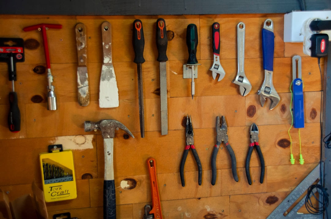 a bunch of tools are hanging on a wall on Hammer & Home