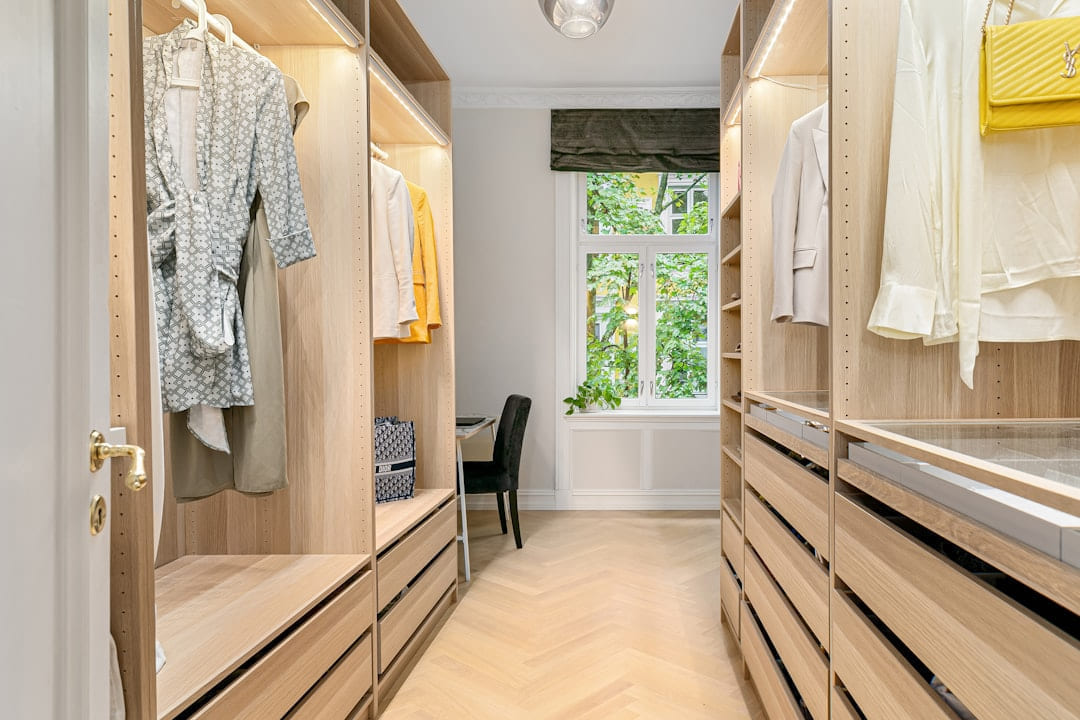 A walk in closet filled with lots of wooden drawers on Hammer & Home
