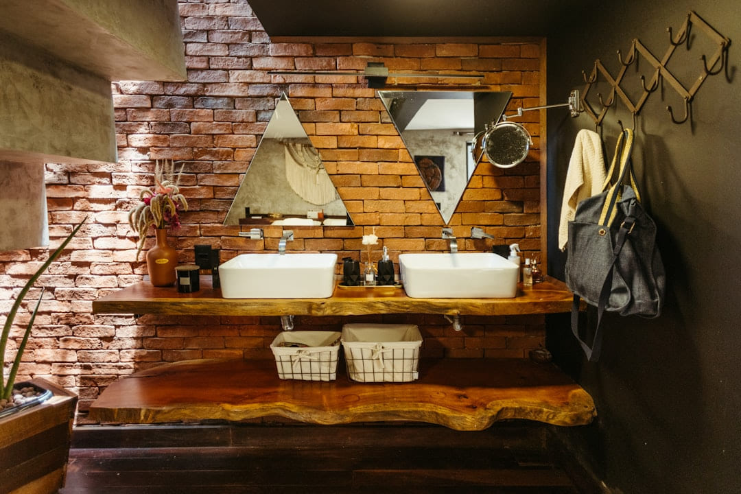 A bathroom with two sinks and a mirror on Hammer & Home