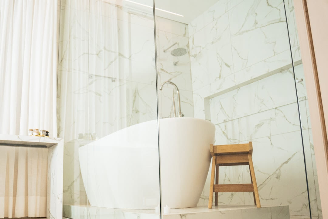 a bathtub and stool in a bathroom on Hammer & Home