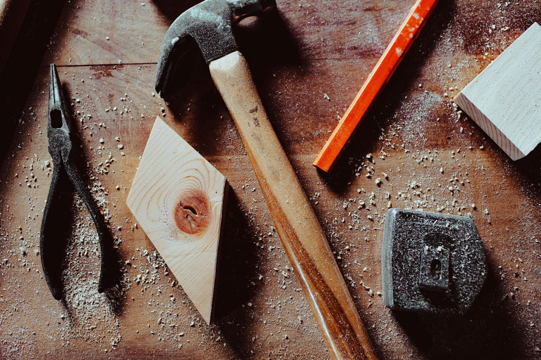 a hammer and a pair of pliers on a table on Hammer & Home