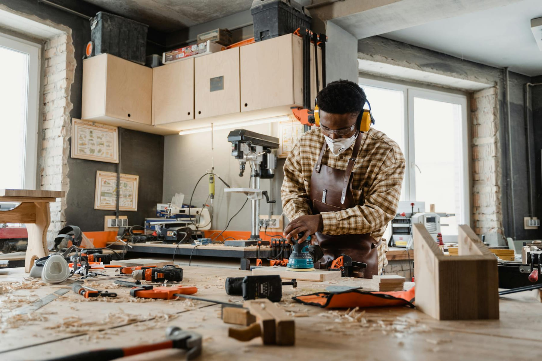 A skilled craftsman working with tools in a well-equipped woodworking workshop. on Hammer & Home