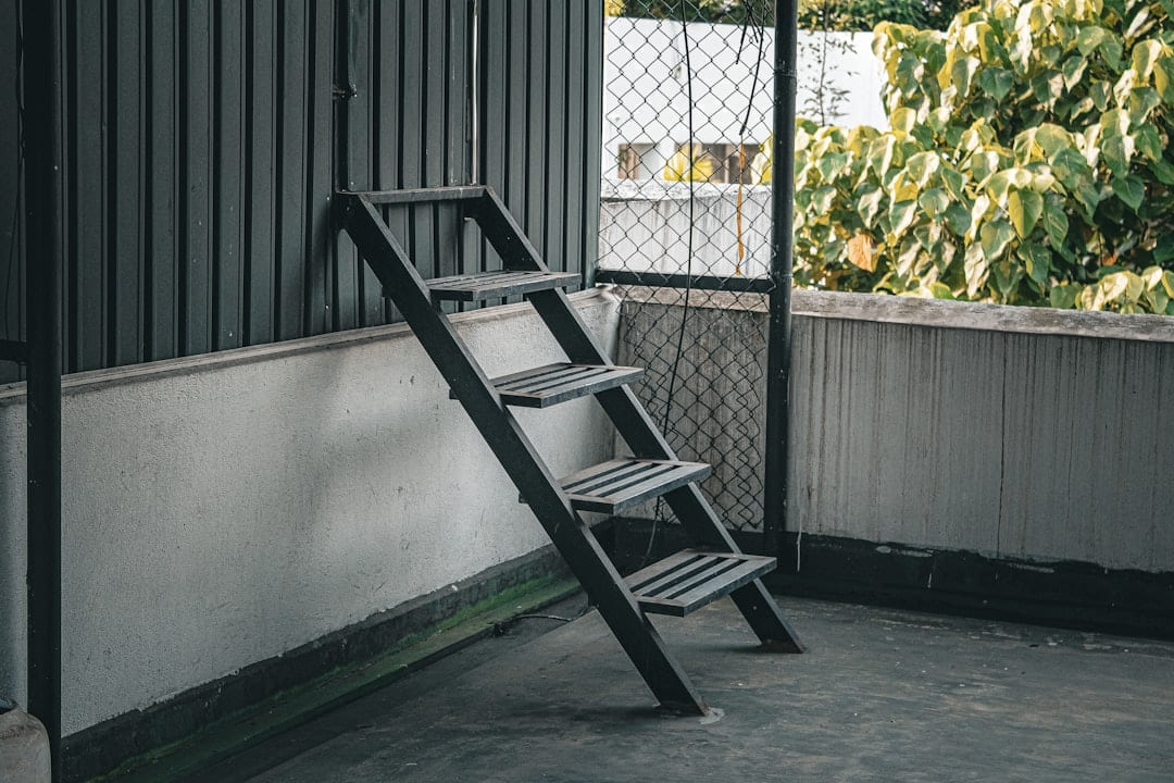 A wooden ladder leans against a wall. on Hammer & Home