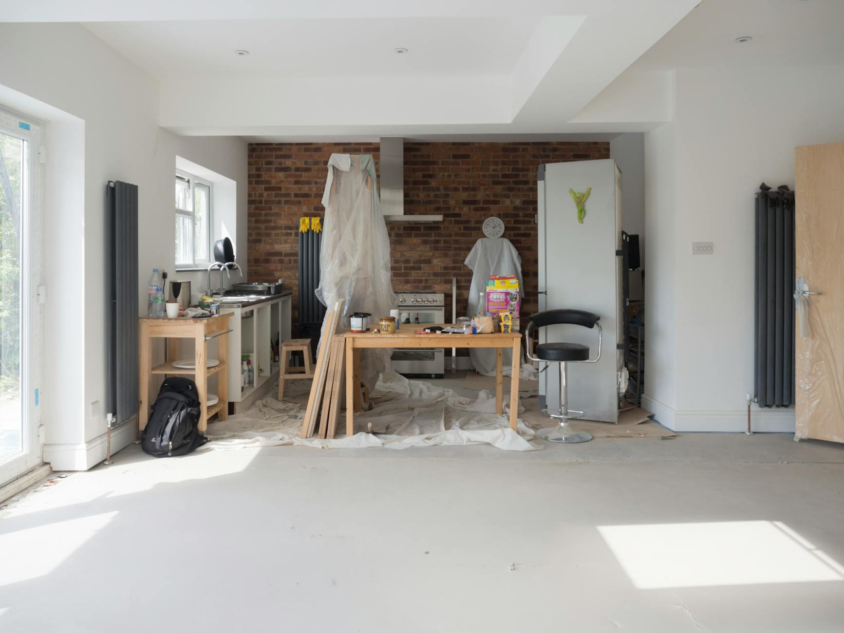 Bright kitchen extension showing renovation work with tools and materials. on Hammer & Home